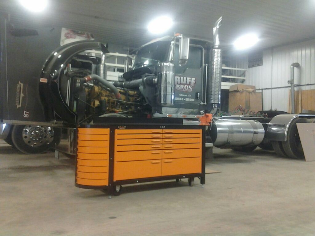 Heavy duty steel workbench in front of big rig truck.